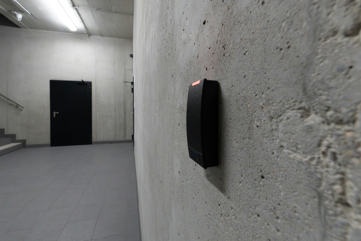 Wall-mounted access-control reader beside a controlled door