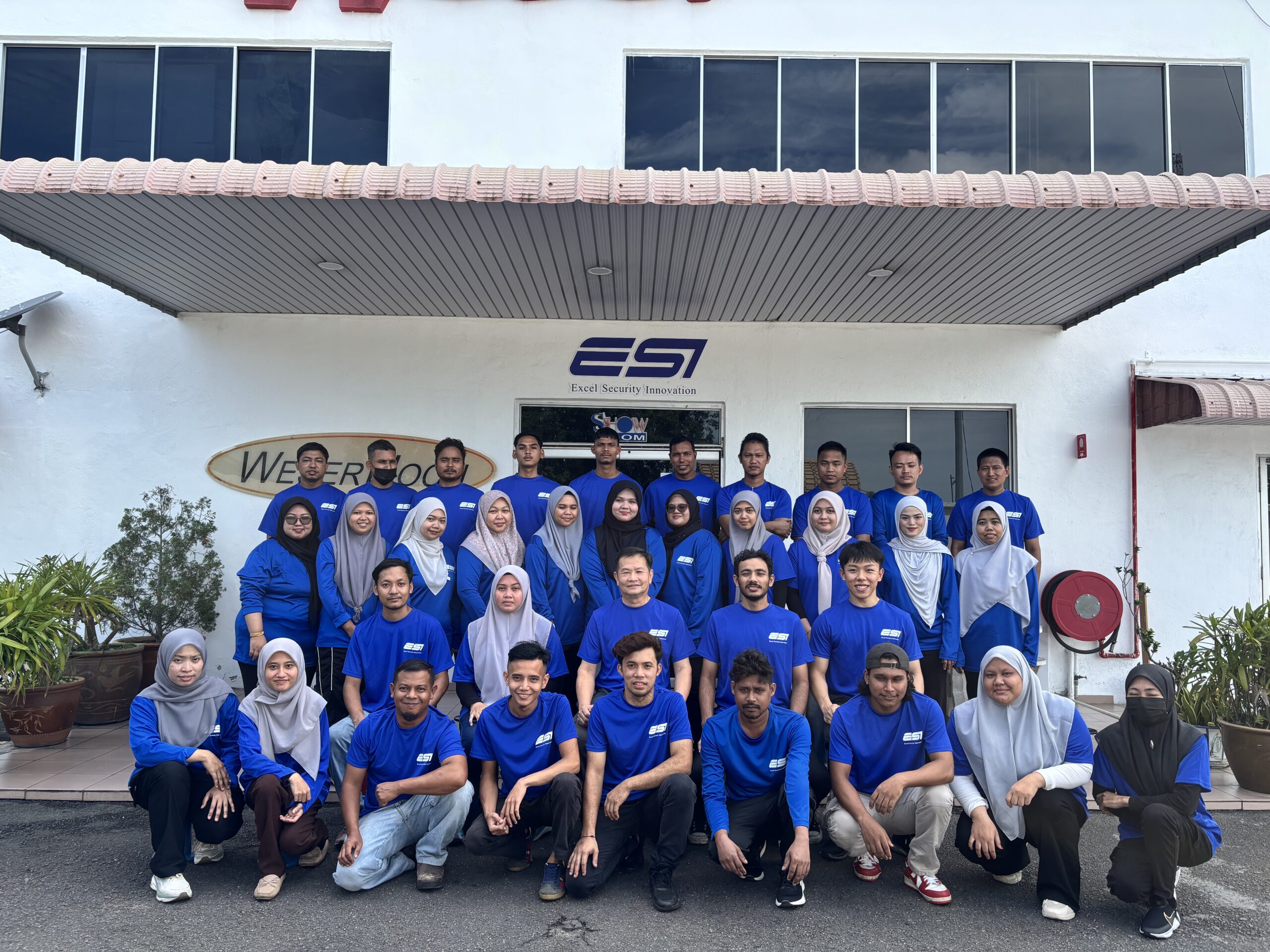The ESI Access production team outside the Merlimau factory at Wisma Weser
